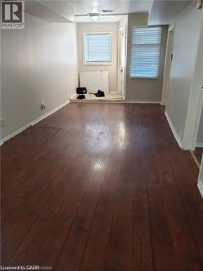 Hamilton house for rent - A room with wooden flooring and white walls.