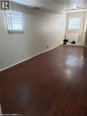 Hamilton house for rent - A room with wooden flooring and a window with blinds.