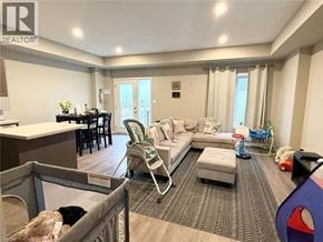 Welland townhouse for rent - A living room with a grey sofa and a grey chair.