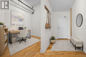 Carleton Place multi-family for rent - A well-lit room with a desk, chair, and a bench.
