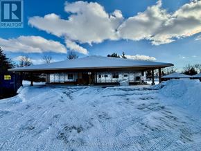 Centre Hastings multi-family for rent - A snow-covered building with a blue sky and clouds in the background.