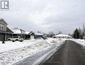 Centre Hastings multi-family for rent - A snowy street with houses on both sides and a car parked on the left.