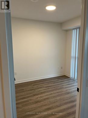 Vaughan (Vaughan Corporate Centre) condo for rent - A room with wooden flooring and white walls.