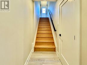 Ottawa house for rent - A long flight of wooden stairs leads to a door.