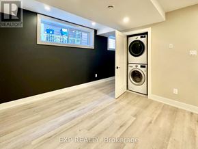 Ottawa house for rent - A laundry room with a washer and dryer built into the wall.