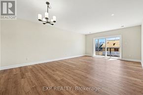 For rent in Russell - A large, empty room with wooden flooring and a chandelier.
