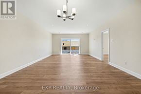 For rent in Russell - A large empty room with wooden floors and a chandelier.