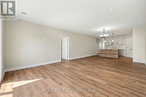 For rent in Russell - A spacious room with wooden flooring and a chandelier.