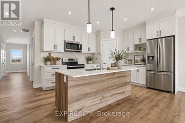 For rent in Russell - A modern kitchen with white cabinets and a wooden island.