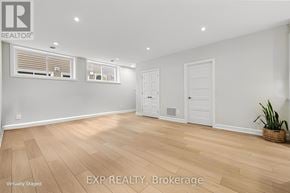 For rent in Russell - A virtual staging of a room with wooden floors and white walls.