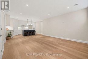 For rent in Russell - A large, empty room with wooden flooring and white walls.