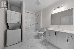 Carleton Place multi-family for rent - A bathroom with a toilet, sink, and a cabinet with a drawer.