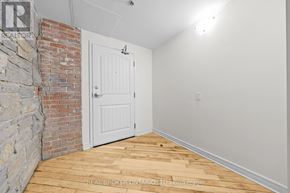 Carleton Place multi-family for rent - A room with a white door and a brick wall.