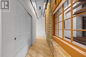 Carleton Place multi-family for rent - A hallway with a white door and a stone wall.