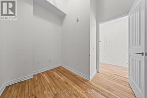 Carleton Place multi-family for rent - A white bathroom with a toilet, sink, and a dryer in the corner.