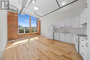 Carleton Place multi-family for rent - A white bathroom with a sink, mirror, and toilet.