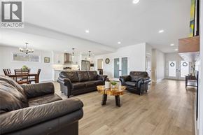 Sarnia house for rent - A living room with brown leather couches and a wooden coffee table.