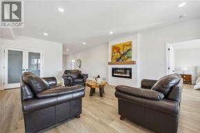 Sarnia house for rent - A living room with black leather furniture and a fireplace.