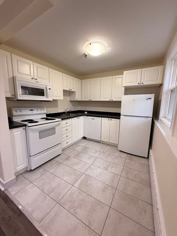 Halifax apartment for rent - A kitchen with white appliances and cabinets.