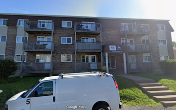 Halifax apartment for rent - A white van is parked in front of a building with the number 15 on it.