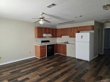 Albany apartment for rent - A kitchen with wooden floors and white appliances.