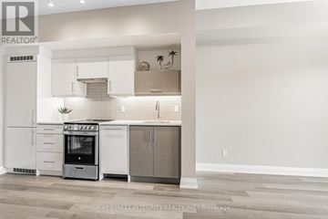 Toronto (Kensington-Chinatown) condo for rent - A modern kitchen with white cabinets and a stainless steel oven.