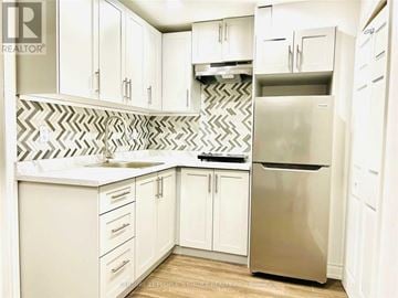 Milton (Co Coates) house for rent - A kitchen with white cabinets and a stainless steel refrigerator.