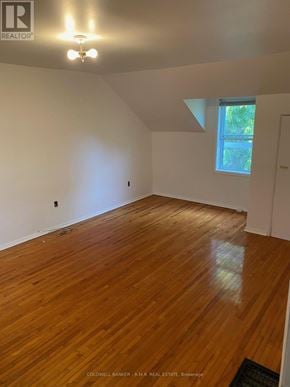 Cobourg duplex for rent - A room with wooden flooring and a window letting in natural light.