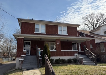 Louisville apartment for rent - A red brick house with a white door and windows.