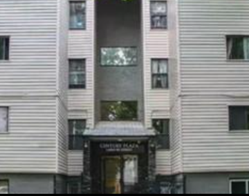 Edmonton apartment for rent - A building with a black awning and a glass window.