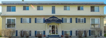 Edmonton apartment for rent - A two-story building with a black awning and a sign that reads "Apartments".
