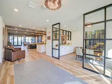 Wildwood apartment for rent - A modern living room with a brown leather couch and a grey rug.