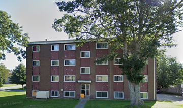 Halifax apartment for rent - A red brick building with a tree in front.