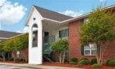 Rocky Mount apartment for rent - A red brick house with a white door and a small porch.