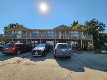 Clinton apartment for rent - Two cars are parked in front of a house.