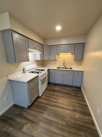 Modesto apartment for rent - A kitchen with a white counter top and a white stove top oven.