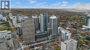 Hamilton apartment for rent - A cityscape with a mix of modern and older buildings, with a clear sky and some clouds.