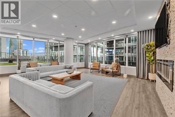 Hamilton apartment for rent - A spacious living room with a large grey sofa and a wooden coffee table.