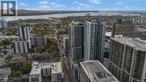 Hamilton apartment for rent - A cityscape with a river in the background and a bridge crossing it.