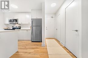St. Thomas condo for rent - A kitchen with white cabinets and a refrigerator.