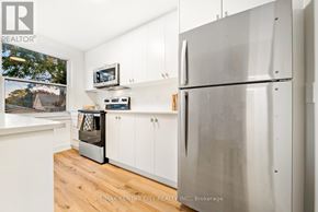 St. Thomas condo for rent - A kitchen with white cabinets and a stainless steel refrigerator.