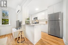 St. Thomas condo for rent - A modern kitchen with white cabinets and a stainless steel refrigerator.