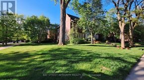 Toronto (Forest Hill South) house for rent - A tree-lined lawn in front of a brick building.