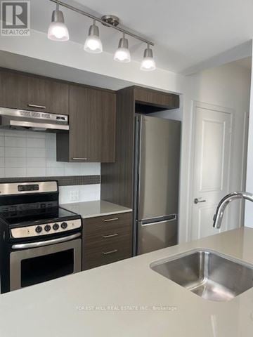 Toronto (Forest Hill South) house for rent - A modern kitchen with a stove top oven, refrigerator, and sink.