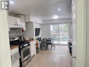 Toronto (University) house for rent - A kitchen with a stove top oven and a dining table with chairs.