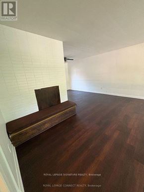 Toronto (West Hill) house for rent - A room with a wooden bench and a white wall.