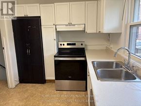 Toronto (West Hill) house for rent - A kitchen with a black fridge, stove, and dishwasher.