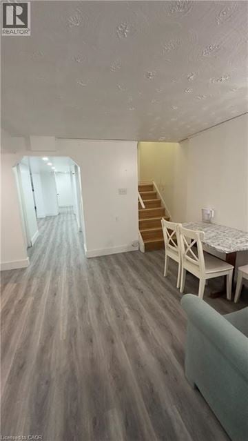 Kitchener house for rent - A living room with a couch, a dining table and a staircase.