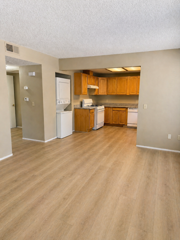 Tracy apartment for rent - A kitchen with wooden cabinets and white appliances.