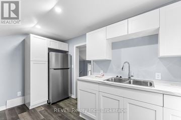 St. Catharines (E. Chester) duplex for rent - A modern kitchen with white cabinets and stainless steel appliances.